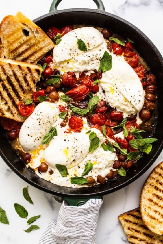 Bursting cherry tomatoes and burrata appetizer