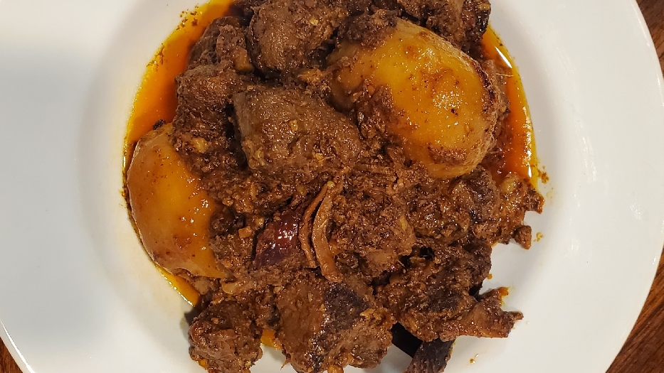 Blackened curried goat with potatoes