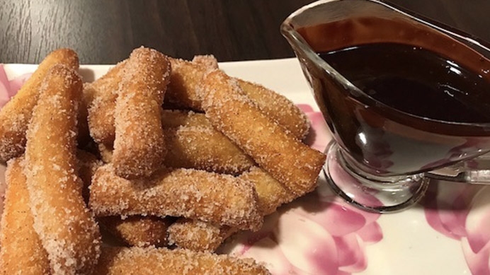 Delicious churros with chocolate sauce