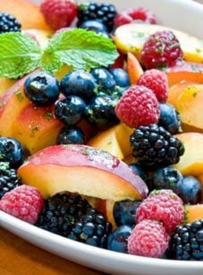 Peaches and berries with lemon-mint syrup