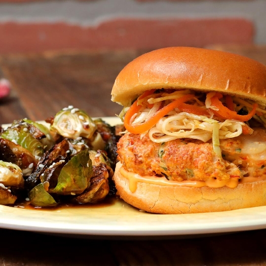 Grilled bang bang shrimp burger with asian brussels sprouts