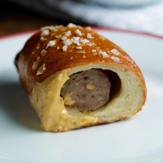 Brats in a blanket with beer mustard cheese sauce